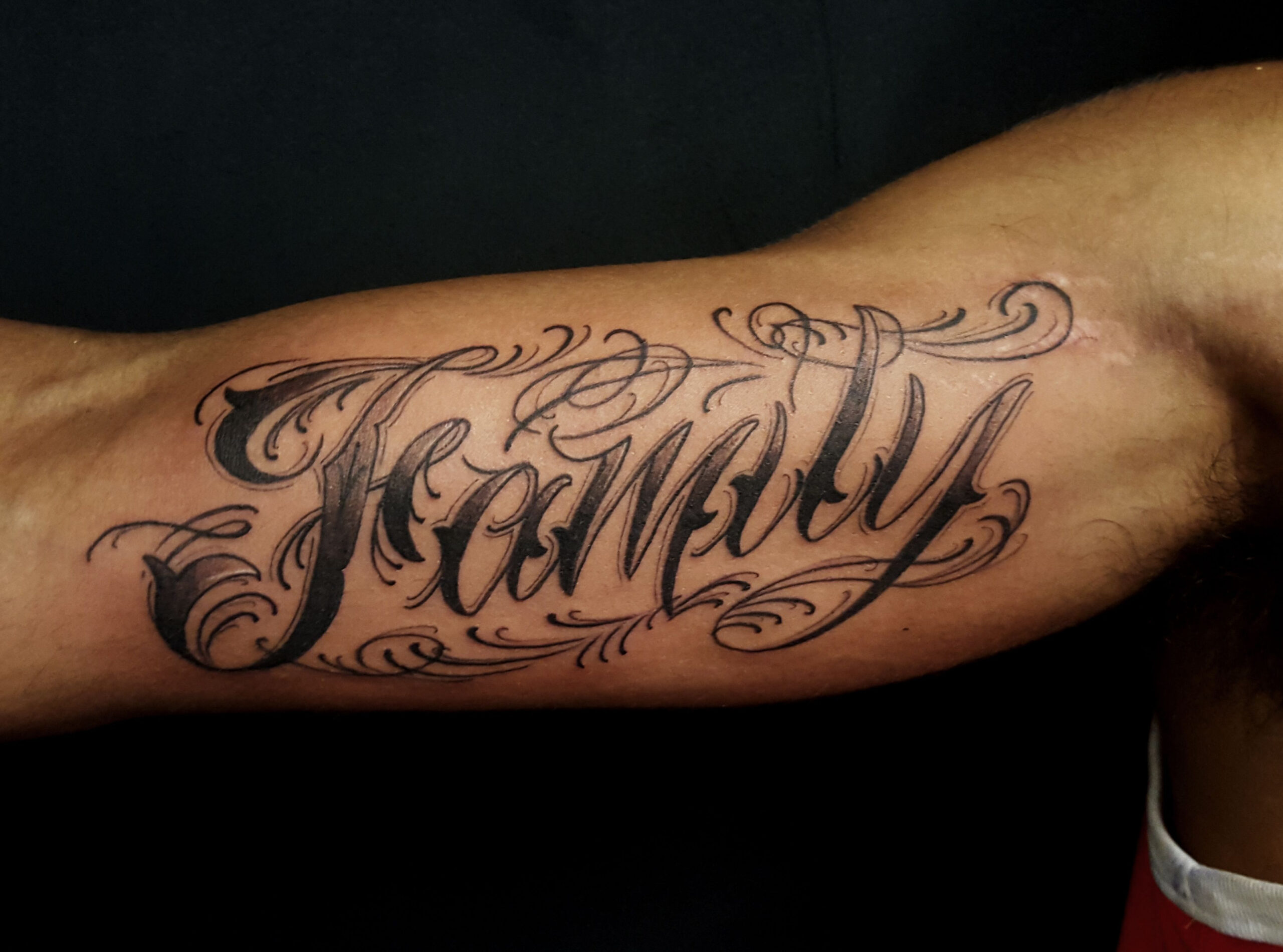 Custom lettering tattoo on inner bicep - Chronic Ink  Picture