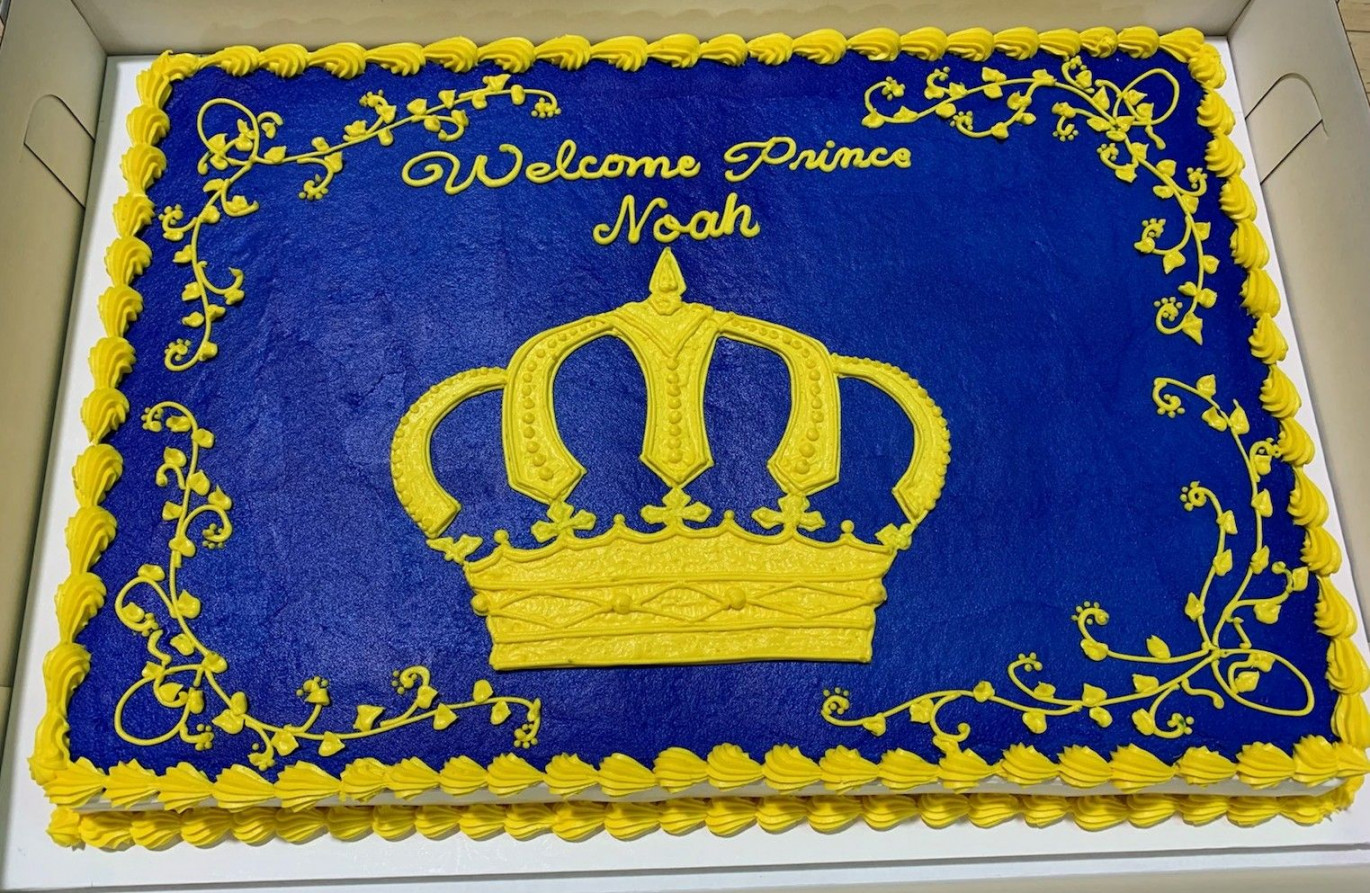 Hand drawn crown and detailed scrolling decorate our sheet cake